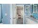 Stylish bathroom with dual sinks, blue accents, and a view into the connected bedroom at 5253 Quillback Ln, St Cloud, FL 34771
