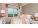 Cozy bedroom with pink accents, a view to the outside, and a stylish bedside table at 5253 Quillback Ln, St Cloud, FL 34771