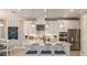 Bright kitchen features an island with seating, stainless steel appliances, and white cabinets at 5253 Quillback Ln, St Cloud, FL 34771