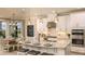 Modern kitchen with white cabinets, granite countertops, stainless steel appliances, and a large island at 5253 Quillback Ln, St Cloud, FL 34771