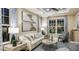 Elegant living room with stylish furniture, large windows, a ceiling fan, and modern artwork at 5253 Quillback Ln, St Cloud, FL 34771