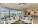 Bright living room with an open floor plan, stylish furnishings, and large sliding glass doors to the outdoor living space at 5253 Quillback Ln, St Cloud, FL 34771