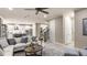 An open-concept living room with a view of the kitchen and a staircase at 5253 Quillback Ln, St Cloud, FL 34771