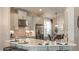 Modern kitchen featuring stainless steel appliances, a center island with seating, and sleek countertops at 5271 Quillback Ln, St Cloud, FL 34771