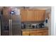 Bright kitchen featuring stainless steel appliances, granite countertops and a light wood cabinets at 614 Gaul Way, Kissimmee, FL 34759