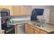 Well-equipped kitchen boasting stainless steel appliances, granite counters and a spacious sink at 614 Gaul Way, Kissimmee, FL 34759