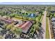 An aerial view of the property shows a lovely pond, trees, and roadways nearby at 6218 Forsythe Loop, Sanford, FL 32771