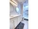 Modern bathroom featuring double sinks, marble-tiled shower, and updated fixtures at 6218 Forsythe Loop, Sanford, FL 32771