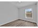 This bedroom features wood floors and a bright window offering natural light at 6218 Forsythe Loop, Sanford, FL 32771