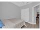 This bedroom features wood floors, a ceiling fan, and a double door closet at 6218 Forsythe Loop, Sanford, FL 32771