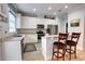 Well-lit kitchen with stainless steel appliances and breakfast bar with seating at 6218 Forsythe Loop, Sanford, FL 32771