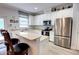 Bright kitchen featuring stainless steel appliances, breakfast bar, and ample cabinet space at 6218 Forsythe Loop, Sanford, FL 32771