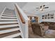 Inviting living room featuring hardwood floors, ceiling fan, and a staircase leading to the upper level at 6218 Forsythe Loop, Sanford, FL 32771