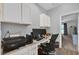 This office features cabinets above the desk and is conveniently near a door at 6218 Forsythe Loop, Sanford, FL 32771