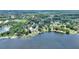 Stunning aerial view of lakefront homes surrounded by lush greenery, offering serene waterfront living at 731 Rosemere Cir, Orlando, FL 32835