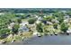 Breathtaking aerial view of a lakeside property featuring a pool, private dock, and lush landscaping at 731 Rosemere Cir, Orlando, FL 32835
