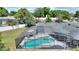 Aerial view of a screened pool and outdoor living space, surrounded by a lush green yard at 731 Rosemere Cir, Orlando, FL 32835