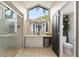 Bright bathroom featuring a large window, vanity, shower, and toilet at 731 Rosemere Cir, Orlando, FL 32835