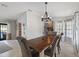 Bright dining room featuring hardwood floors, a wooden table with upholstered chairs, and decorative light fixture at 731 Rosemere Cir, Orlando, FL 32835