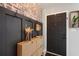 Stylish entryway features a brick accent wall, coat rack, and shoe storage at 731 Rosemere Cir, Orlando, FL 32835