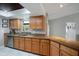 Well-lit kitchen featuring granite counters, mosaic backsplash, stainless steel dishwasher, and ample wooden cabinetry at 731 Rosemere Cir, Orlando, FL 32835