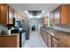 Modern kitchen with stainless steel appliances, tile floors, and granite countertops at 731 Rosemere Cir, Orlando, FL 32835