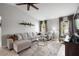 Open-concept living room with neutral color palette, tile floors, and a large sectional sofa at 731 Rosemere Cir, Orlando, FL 32835