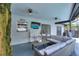 Inviting covered patio with comfortable seating, a mounted TV, and access to the pool area at 731 Rosemere Cir, Orlando, FL 32835