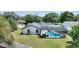 Aerial view of the backyard screened-in pool, with a patio area and an umbrella covered table at 731 Rosemere Cir, Orlando, FL 32835