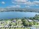 Stunning aerial view of lakefront homes with lush landscaping and city skyline backdrop at 7420 Lake Willis Dr, Orlando, FL 32821