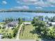 Aerial view showing the house on a large lot with meticulously planted rows of trees and lakefront access at 7420 Lake Willis Dr, Orlando, FL 32821
