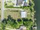 Aerial view of property showcasing the house and its expansive, well-manicured yard with lake access at 7420 Lake Willis Dr, Orlando, FL 32821