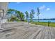 Large deck overlooking a beautiful lake with green trees at 7420 Lake Willis Dr, Orlando, FL 32821