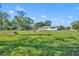 Backyard featuring lush lawn, ample space, landscaping features, and a well-maintained perimeter at 7420 Lake Willis Dr, Orlando, FL 32821
