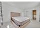 Spacious bedroom with a neutral color scheme, features a modern bed, and closet space at 7420 Lake Willis Dr, Orlando, FL 32821