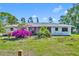 Exterior of home with lush bougainvillea in the front yard at 7420 Lake Willis Dr, Orlando, FL 32821