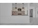 Bright kitchen featuring granite counters, designer lighting, and sleek white cabinetry at 7420 Lake Willis Dr, Orlando, FL 32821