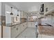 Bright kitchen featuring granite counters, designer lighting, and sleek white cabinetry at 7420 Lake Willis Dr, Orlando, FL 32821
