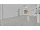 Bright living room featuring marble floors, white walls, and abundant natural light from a large window at 7420 Lake Willis Dr, Orlando, FL 32821