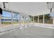 Bright sunroom with large windows offering water views at 7420 Lake Willis Dr, Orlando, FL 32821