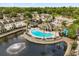 Aerial view of a community pool, pond, and playground near apartments at 10154 Regent Square Dr # 201, Orlando, FL 32825