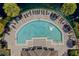 Aerial view of a luxurious semi-circular pool, surrounded by lounge chairs at 10154 Regent Square Dr # 201, Orlando, FL 32825