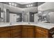 Elegant bathroom showcasing a dual-sink vanity with a well-lit mirror and cabinetry at 10154 Regent Square Dr # 201, Orlando, FL 32825