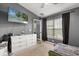 Relaxing bedroom featuring a large dresser and window, creating a comfortable retreat at 10154 Regent Square Dr # 201, Orlando, FL 32825