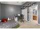 Well-lit bedroom with an organized workspace and ensuite bathroom, perfect for productivity at 10154 Regent Square Dr # 201, Orlando, FL 32825