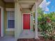 Charming entryway featuring a red front door and a column at 10154 Regent Square Dr # 201, Orlando, FL 32825