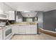 Well-lit kitchen with white cabinets, tile floors and breakfast bar at 10154 Regent Square Dr # 201, Orlando, FL 32825