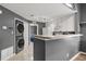 Kitchen featuring stacked washer/dryer and breakfast bar to another room at 10154 Regent Square Dr # 201, Orlando, FL 32825