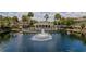 Community pond with fountain, pool, clubhouse, and lush landscaping at 10154 Regent Square Dr # 201, Orlando, FL 32825