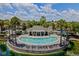 Community pool features palm trees and seating areas for outdoor relaxation at 10154 Regent Square Dr # 201, Orlando, FL 32825